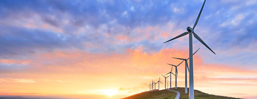 clean energy pink and blue sky with wind turbines